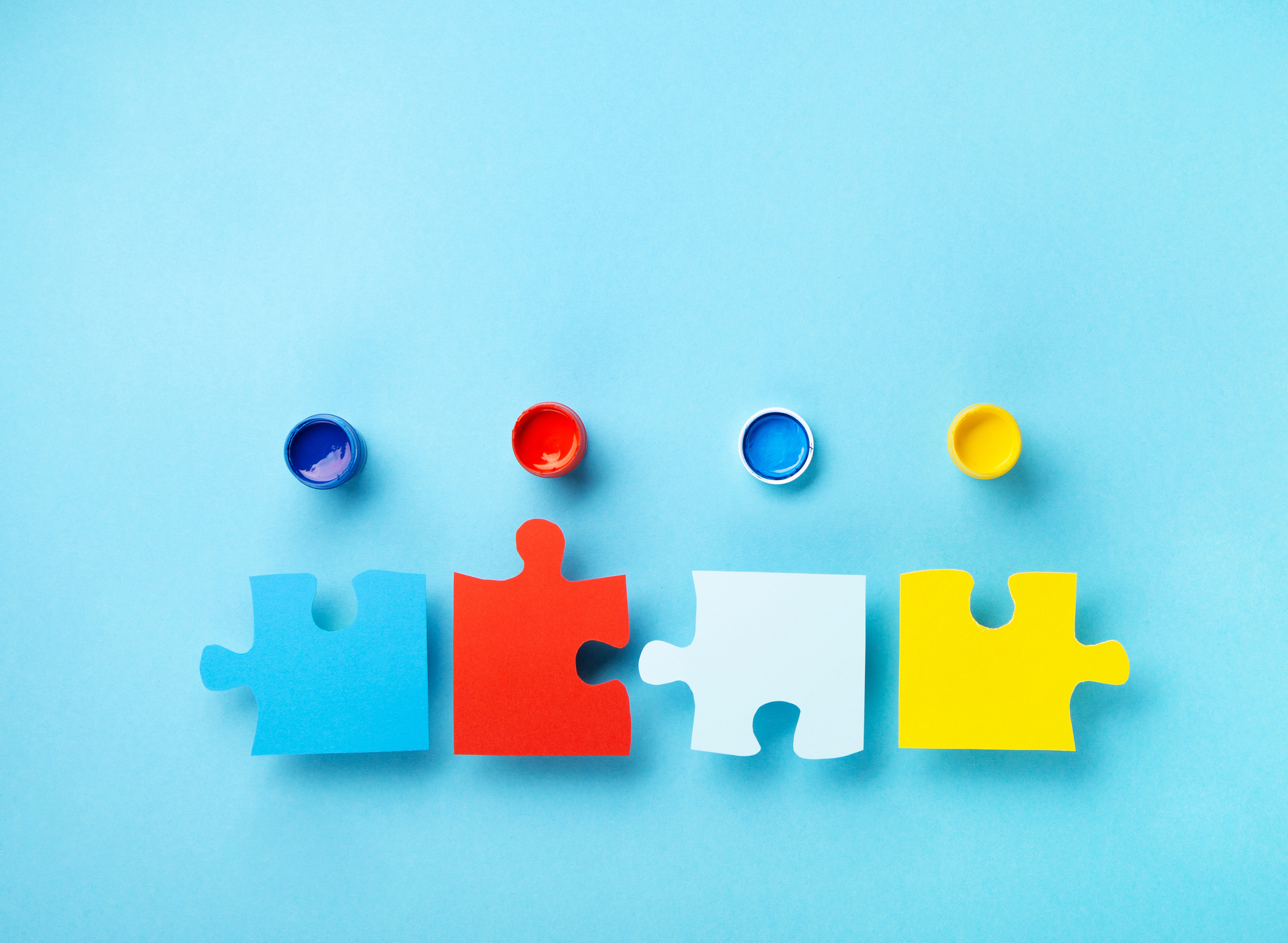 World Autism Awareness Day Card, colorful Puzzles on Blue Background.